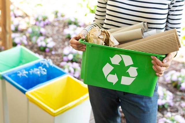 Woman holding a recycling bin | Blog | Greystar